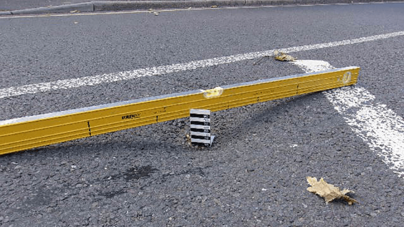 A pothole being measured