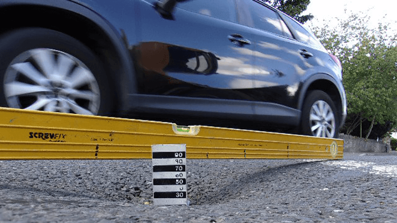 A pothole being measured