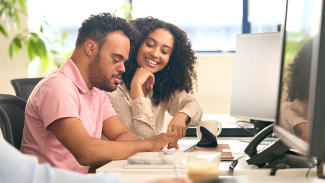 Two people working on a desk