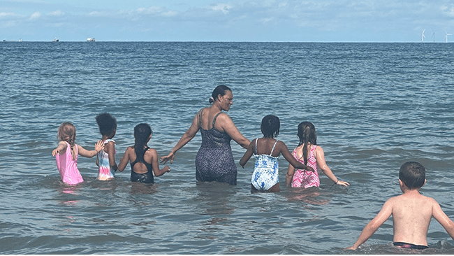 A person and children in the water